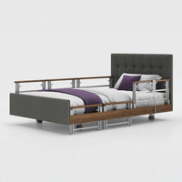 Opera Beds Signature Comfort Plus Profiling Bed with wood accents, white bedding, purple blanket and pillow, front view.