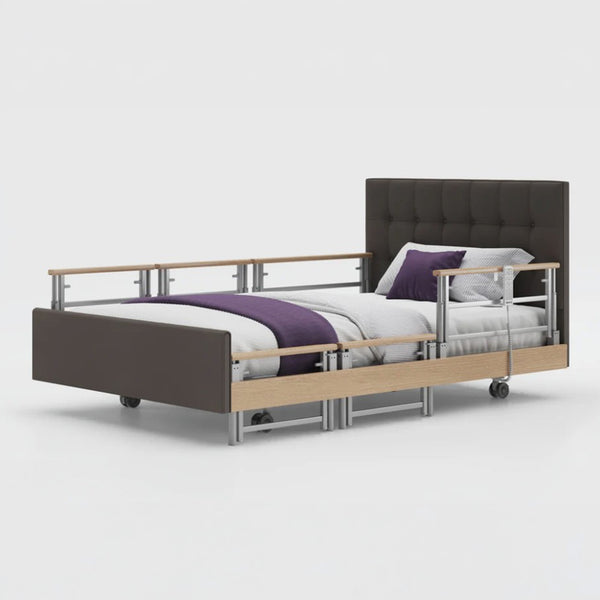 Signature Comfort Plus Profiling Bed with side rails, leatherette frame and white bedding, side view.