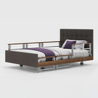 Opera Beds Signature Comfort Plus Profiling Bed with upholstery, white bedding and purple blanket, side view.