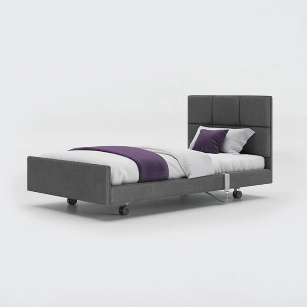 Opera Beds Signature Comfort Profiling Bed with adjustable frame, white bedding and four wheels, side view.