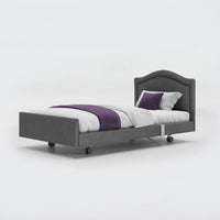 Opera Beds Signature Comfort Profiling Bed with wheels and bedding on a plain white background, side view.