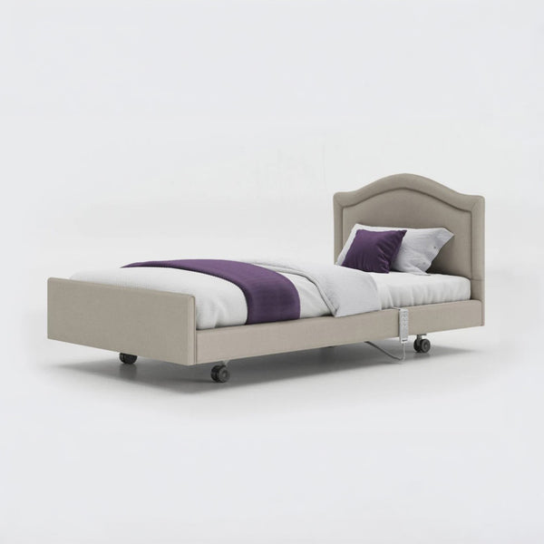 Profiling bed with white bedding, purple blanket and pillow on a plain white background, front view.