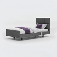 Opera Beds Signature Comfort Profiling Bed with modern upholstered frame, white bedding and purple accents, front view.