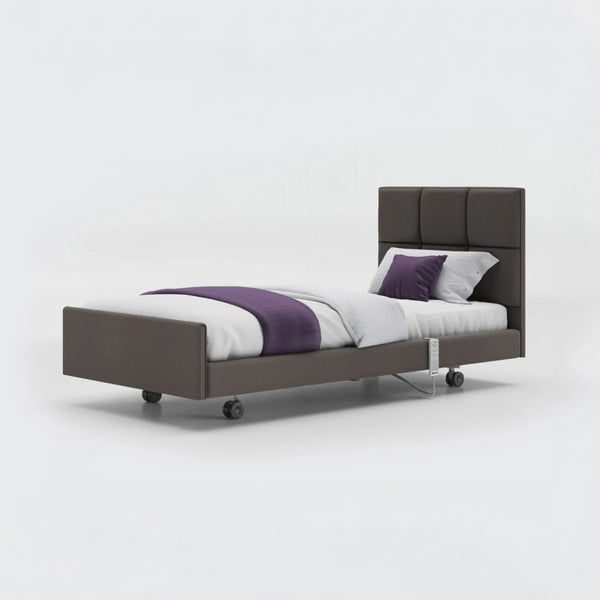 Opera Beds Signature Comfort Profiling Bed with leatherette, white bedding, purple accents and wheels, side view.