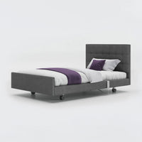 Opera Beds Signature Comfort Profiling Bed with white bedding and purple blanket, plain background, front view.