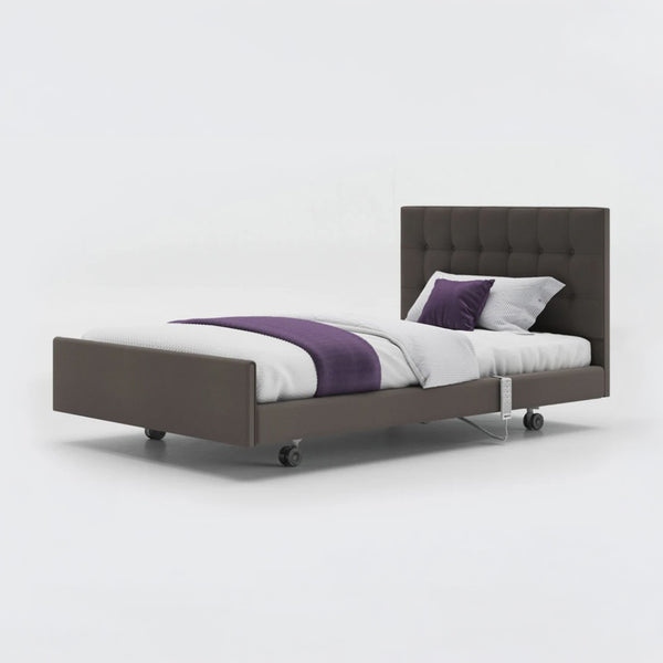 Opera Beds Signature Comfort Profiling Bed with leatherette frame, tufted headboard, wheels and white bedding, front view.