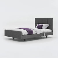 Opera Beds Signature Comfort Profiling Bed with white bedding and purple throw on plain background, front view.