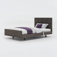Profiling bed with leatherette frame, padded headboard, and coloured accents, shown from front angle.