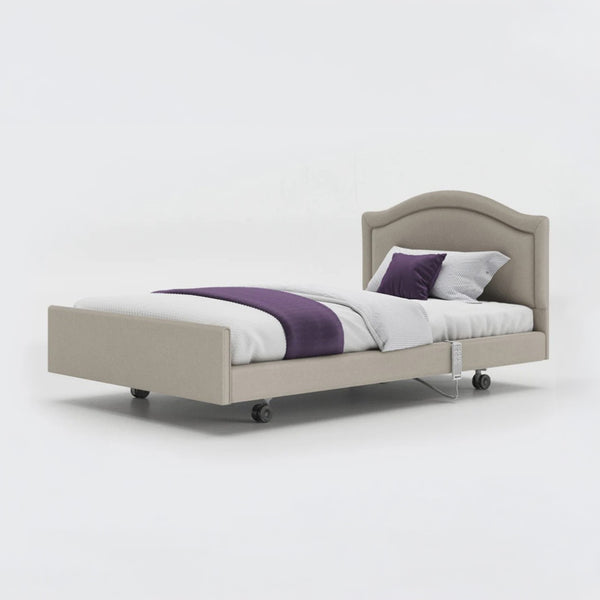 Opera Beds Signature Comfort Profiling Bed with fabric frame, white bedding, purple runner and two pillows, front view.