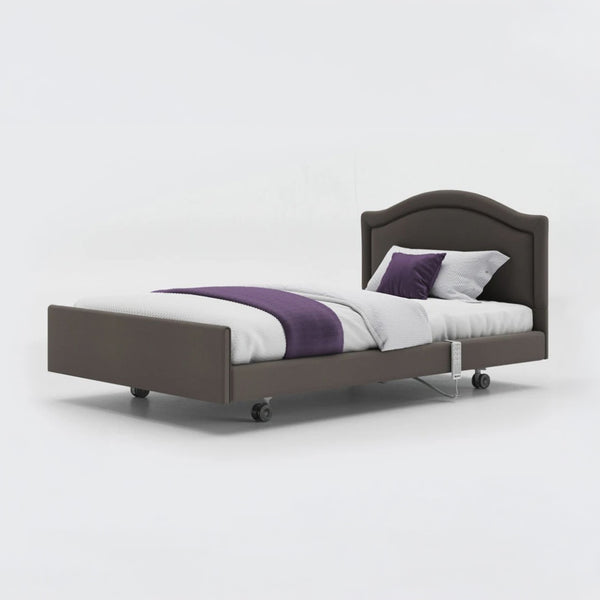 Opera Beds Signature Comfort Profiling Bed with white bedding, purple runner and wheels on a plain background, front view.