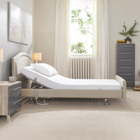 Signature Comfort Profiling Bed by Opera Beds in a modern bedroom with light walls, window, and contemporary furniture, front view.