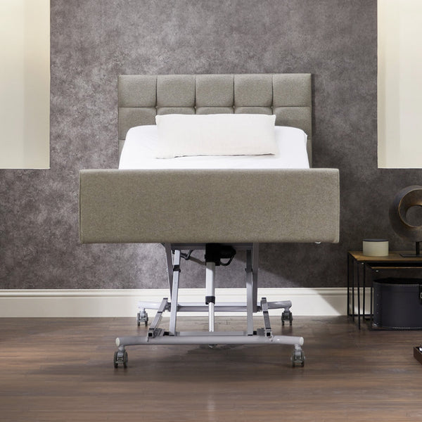 Opera Beds Signature Comfort Profiling Bed with raised head section, white pillow and modern decor, side view.