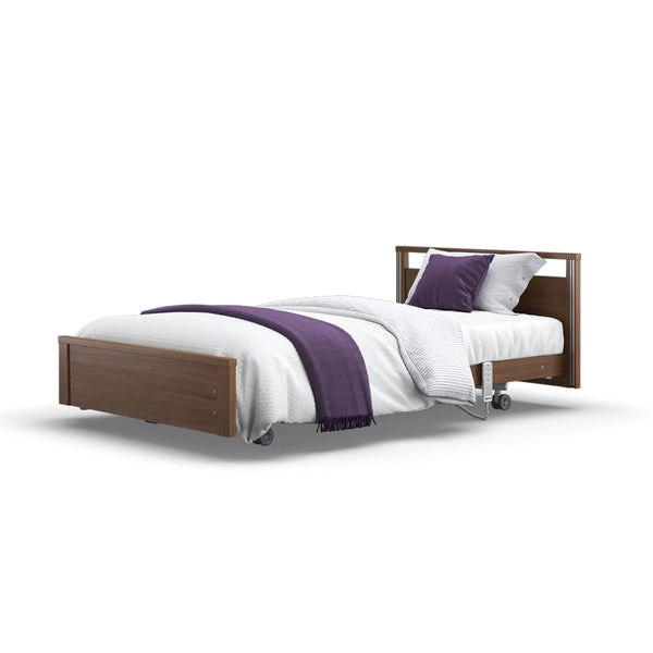 Opera Beds Signature Low Footboard Profiling Bed with white bedding, purple blanket, two purple pillows and wheels, front view.