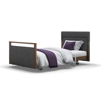 Opera Beds Signature Upholstered Profiling Bed with adjustable frame, white bedding and purple blanket, front view.