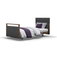 Opera Beds Signature Upholstered Profiling Bed with white bedding and purple accents on white background, front view.