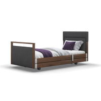 Opera Beds Signature Upholstered Profiling Bed with wood frame, fabric headboard and two pillows, front view.