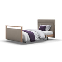 Opera Beds Signature Upholstered Profiling Bed, adjustable with wheels, linen fabric, white bedding, purple accents, side view.