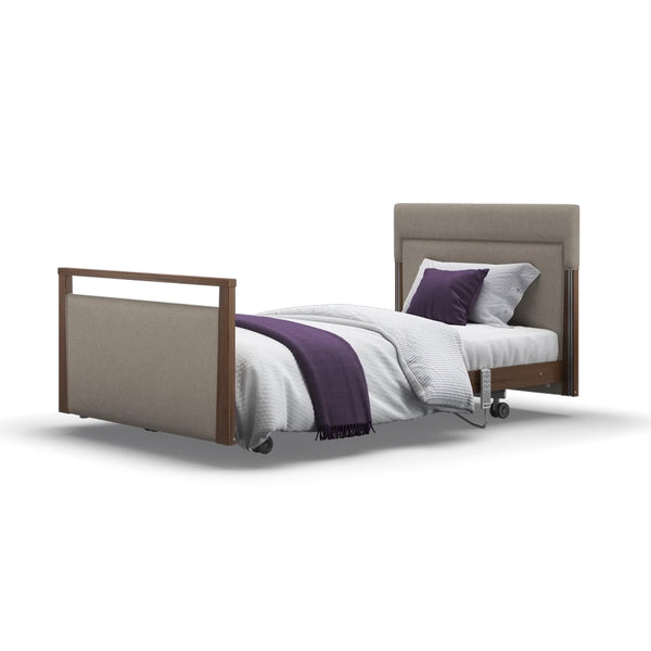 Signature Upholstered Profiling Bed with headboard, footboard, white bedding, purple blanket and wheels, front view.