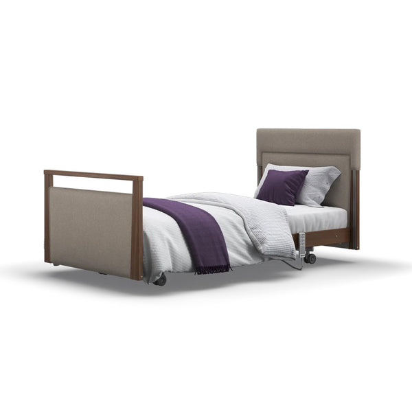 Signature Upholstered Profiling Bed with linen fabric, brown frame, beige headboard, white bedding and purple accents, front view.