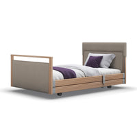 Signature Upholstered Profiling Bed with headboard, side rails, and bedding accents in linen fabric, front view.