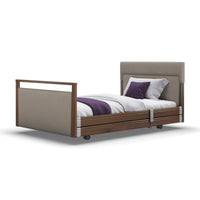 Signature Upholstered Profiling Bed with headboard, white bedding, purple accents on white background, front view.