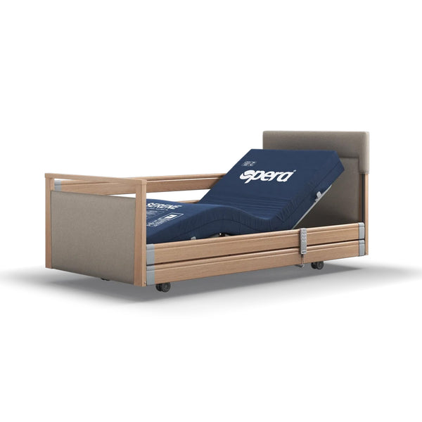 Signature Upholstered Profiling Bed with linen fabric, wooden frame, metal rails, adjustable head and knee sections, side view.