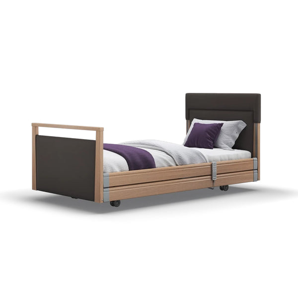Opera Beds Signature Upholstered Profiling Bed with wood accents and purple pillows, angled view.