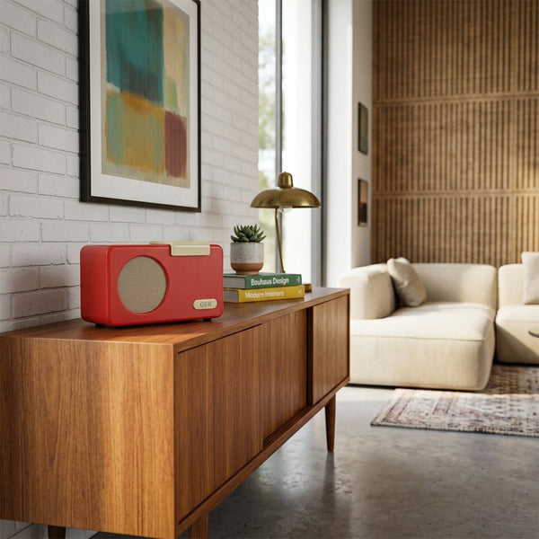 OER Simple Music Player on a wooden sideboard in a modern living room with wall art, lamp, and beige sofa, front view.