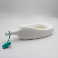 Homecraft Slipper Urinal with cap, plastic design, displayed on its side against a plain white background, side view.