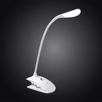 The Daylight Company Smart Clip-On Lamp with flexible LED arm illuminated against a dark gradient background, front view.