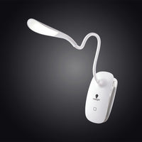 The Daylight Company Smart Clip-On Lamp with touch button, illuminated against a dark background, front view.