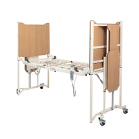 Solite Pro Ultra Low Bed with wooden panels, metal frame and castors, shown partially folded in upright position, side view.