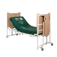 Drive Solite Pro Ultra Low Bed with mattress, wooden head and footboards, and wheels, shown from side view.