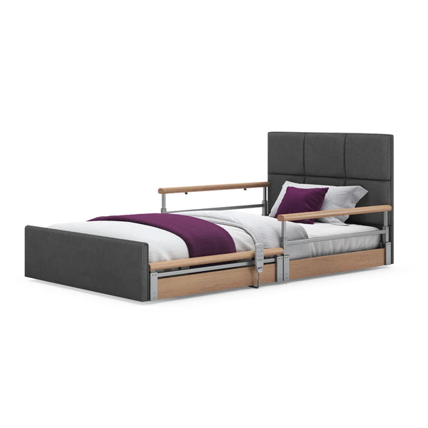 Opera Beds Solo Comfort Plus Profiling Floor Bed with side rails, white bedding, purple blanket and pillow, front view.