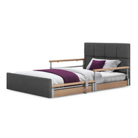 Opera Beds Solo Comfort Plus Profiling Floor Bed with wooden rails, white bedding, and a purple throw pillow, front view.