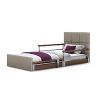 Opera Beds Solo Comfort Plus Floor Bed with wooden rails, white bedding, purple blanket and pillow, front angle.