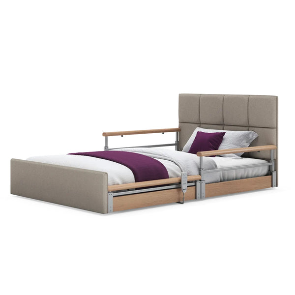 Opera Beds Solo Comfort Plus Profiling Floor Bed with wooden rails and bedding, linen fabric upholstery, angled side view.