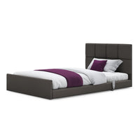 Solo Comfort profiling floor bed with white bedding, purple-accented blanket and pillows, front view.