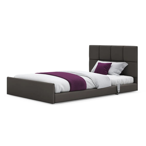 Solo Comfort profiling floor bed with white bedding, purple-accented blanket and pillows, front view.