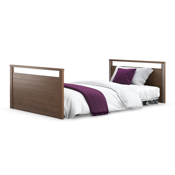 Opera Beds Solo SafeSide Profiling Floor Bed with white bedding, purple pillows and throw, front view.
