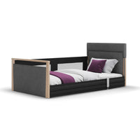 Opera Beds Solo SafeSide Profiling Floor Bed with safety rail and light wood frame for fall prevention, front view.
