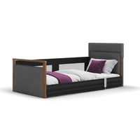 Opera Beds Solo SafeSide Upholstered Profiling Floor Bed with fabric finish, dark frame, white bedding and purple accents, side view.