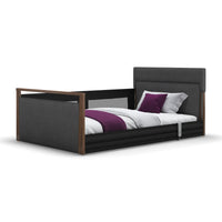 Solo SafeSide Upholstered Profiling Floor Bed by Opera Beds with white bedding and purple accents, front view.