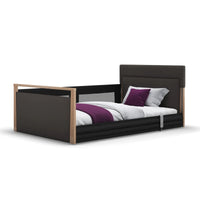 Opera Beds Solo SafeSide Upholstered Profiling Floor Bed with black frame, wood accents, purple blanket, white background, front view.