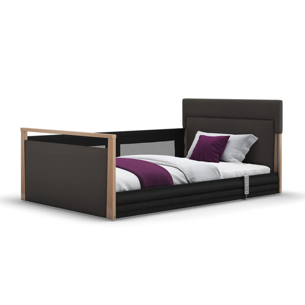 Opera Beds Solo SafeSide Upholstered Profiling Floor Bed with black frame, wood accents, purple blanket, white background, front view.