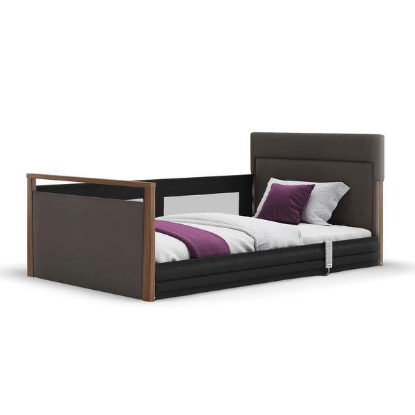 Opera Beds Solo SafeSide upholstered profiling floor bed with leatherette finish and side guardrail, front view.