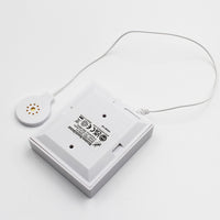 Hearing Products International Sound Sensor Transmitter with attached round corded sensor, tabletop view.