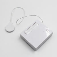 Hearing Products International Sound Sensor Transmitter, rectangular device with round sensor connected by short cable, front view.