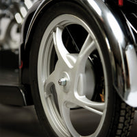 Scooter wheel with thick tyre and metal spokes, close-up view.