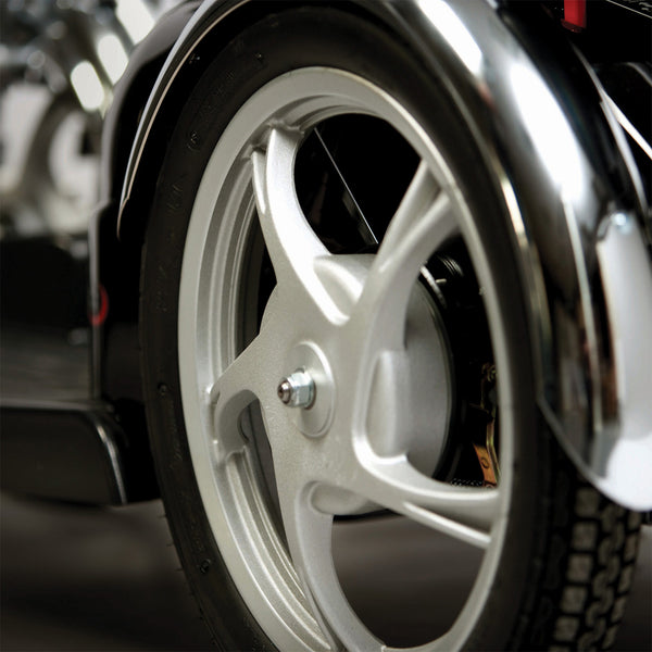 Scooter wheel with thick tyre and metal spokes, close-up view.